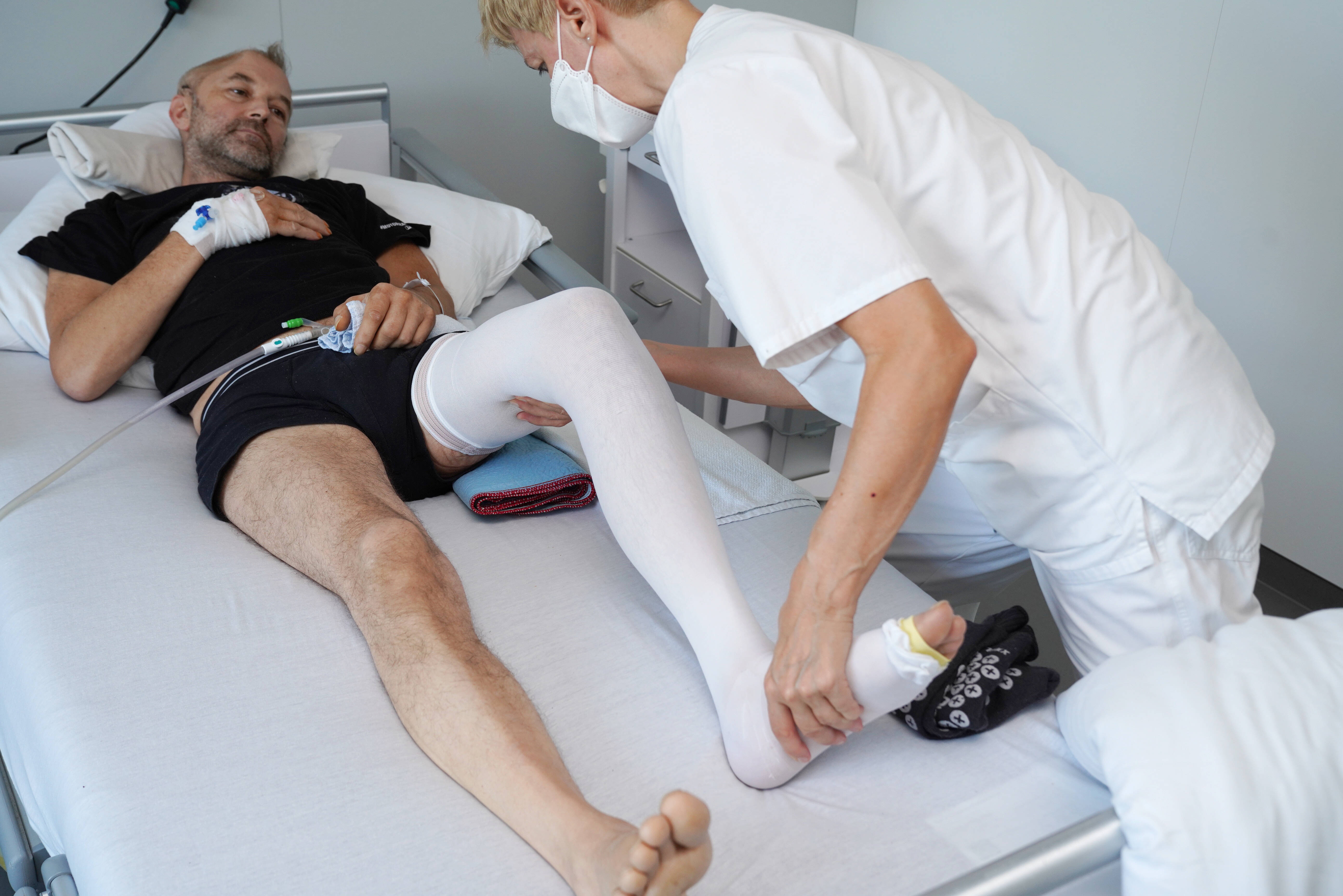 Bedridden neurological patient receiving rehabilitation and positioning care
